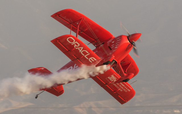 Red plane smoke wings mountains free wallpaper - medium preview image