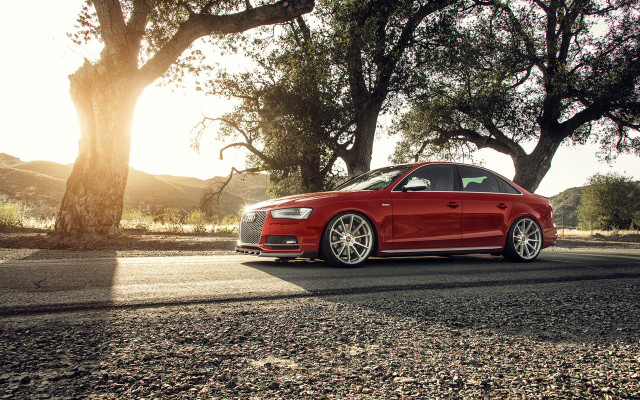 Red car parked trees hill free wallpaper - medium preview image