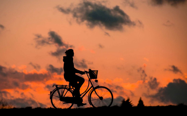 Sunset bicycle silhouette clouds cityscape free wallpaper - medium preview image