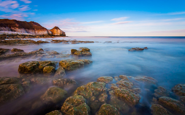 Rocky beach cliff blue sky free wallpaper - medium preview image