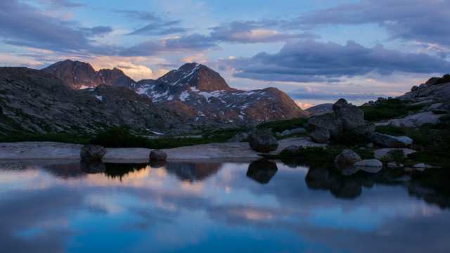 Mountain lake rocks snowy horizon free wallpaper - medium preview image