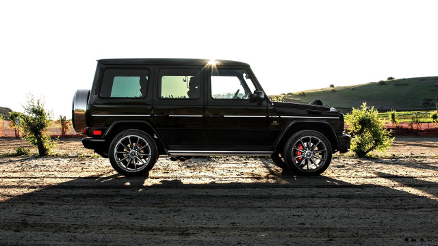 Black suv dirt lot forest free wallpaper - medium preview image