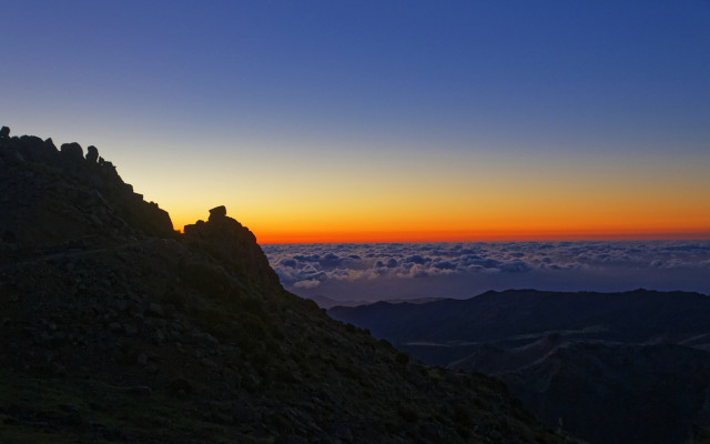 Mountain sunset clouds person ledge free wallpaper - medium preview image