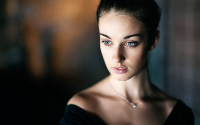 Serious woman necklace portrait blurry free wallpaper - medium preview image