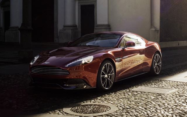 Red car cobblestone street building free wallpaper - medium preview image
