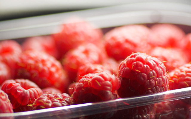 Raspberries plastic container table white free wallpaper - medium preview image