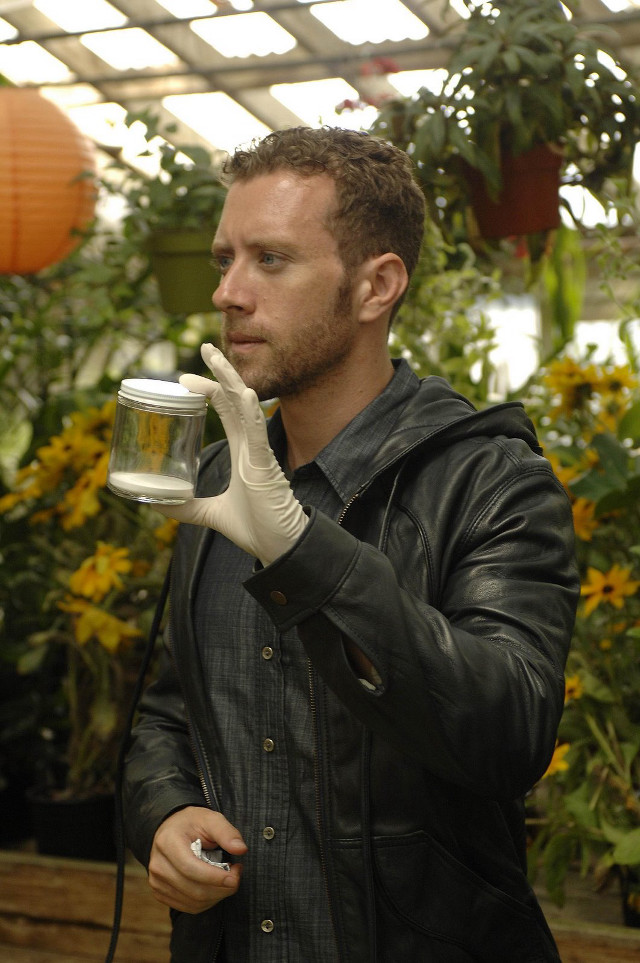 Man black jacket holding coffee free wallpaper - medium preview image