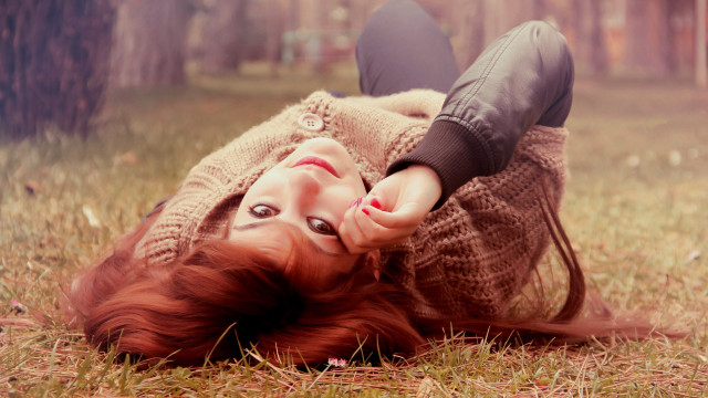 Red haired woman laying in free wallpaper - medium preview image