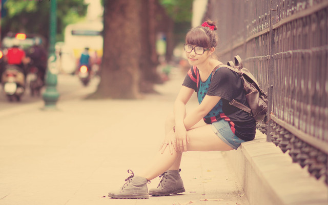 Woman sitting wall backpack crossed free wallpaper - medium preview image