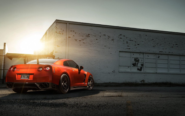 Red sports car backlit building free wallpaper - medium preview image