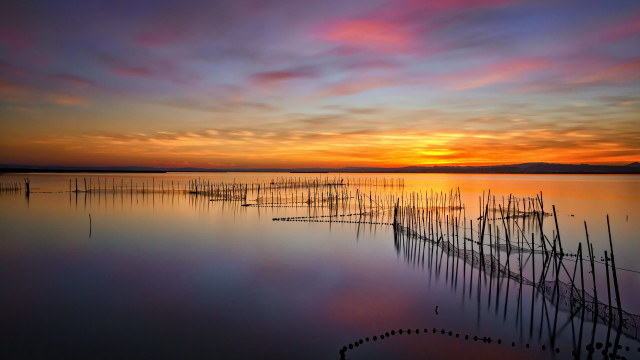 Sunset lake poles boats mystical free wallpaper - medium preview image