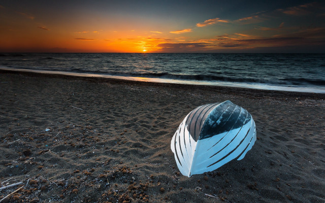 Sandy beach boat sunset ocean free wallpaper - medium preview image