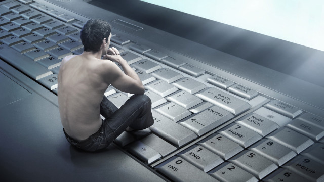 Man sitting keyboard talking phone free wallpaper - medium preview image