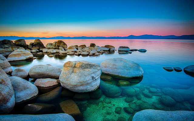 Rocky shore sunset mountains ocean free wallpaper - medium preview image