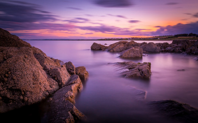 Sunset rocky beach lighthouse reflection free wallpaper - medium preview image