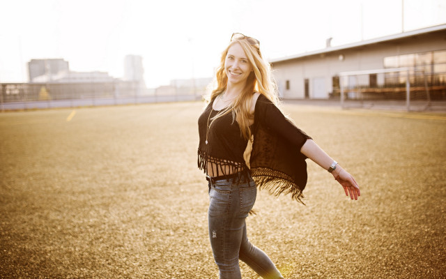 Woman outstretched smiling parkinglot portrait free wallpaper - medium preview image