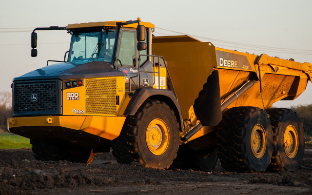 Yellow dump truck dirt field #2 free wallpaper - medium preview image