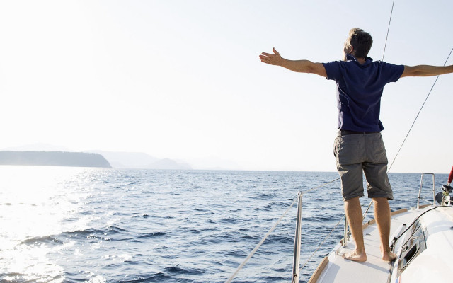 Man boat ocean outstretched arms free wallpaper - medium preview image