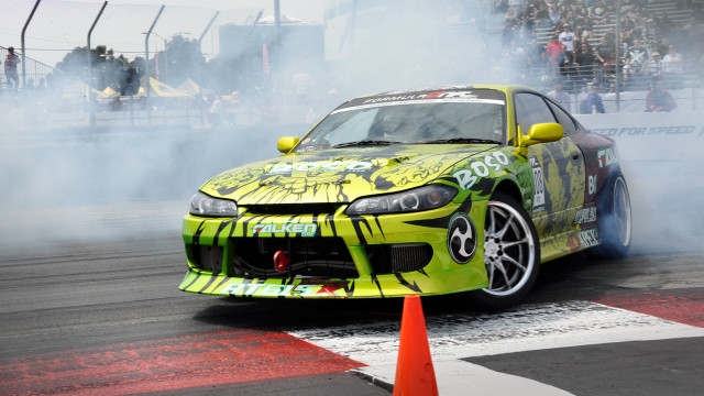 Yellow car smoke track crowd free wallpaper - medium preview image