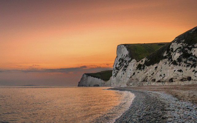 Beach cliff water sunset boat free wallpaper - medium preview image
