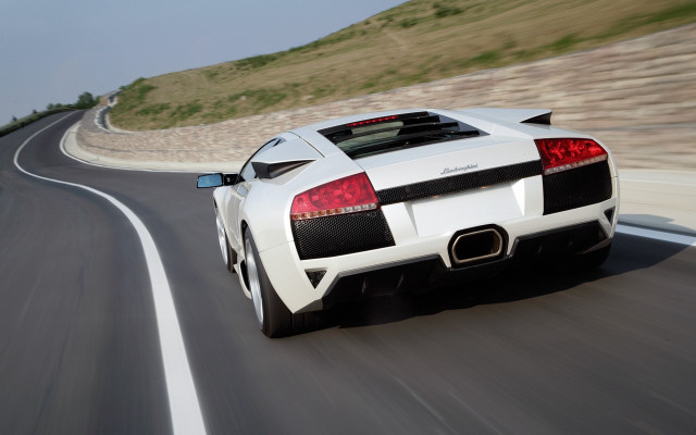 White sports car driving hillside free wallpaper - medium preview image