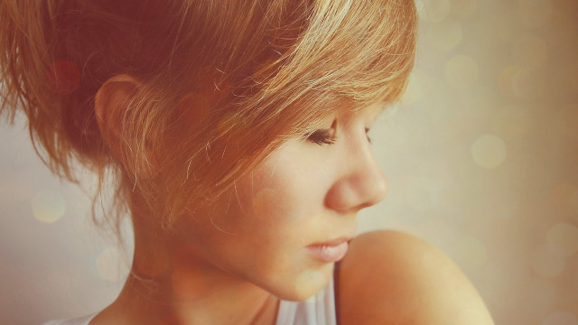 Woman messybun lookingdown closeup realistic free wallpaper - medium preview image