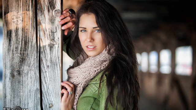 Woman holding door serious look free wallpaper - medium preview image