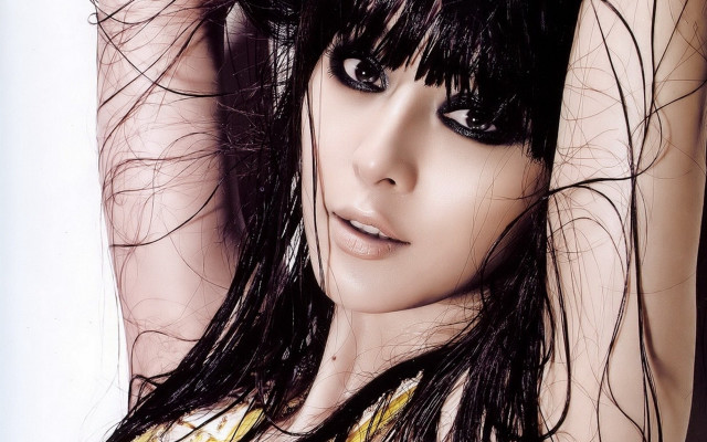 Woman blowing hair black eyes free wallpaper - medium preview image