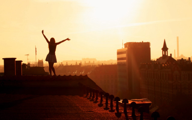 Woman roof outstretched sunrise cityscape free wallpaper - medium preview image