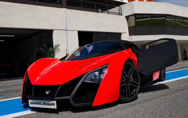 Red sports car parked building free wallpaper - medium preview image