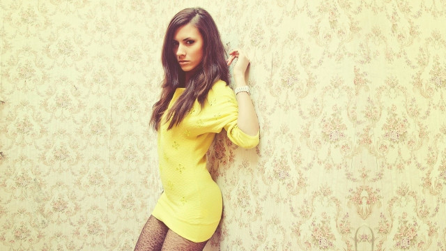 Woman yellow dress wall leaning free wallpaper for desktop - medium preview image
