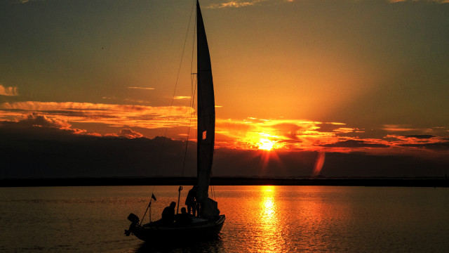 Sailboat sunset water clouds horizon free wallpaper - medium preview image