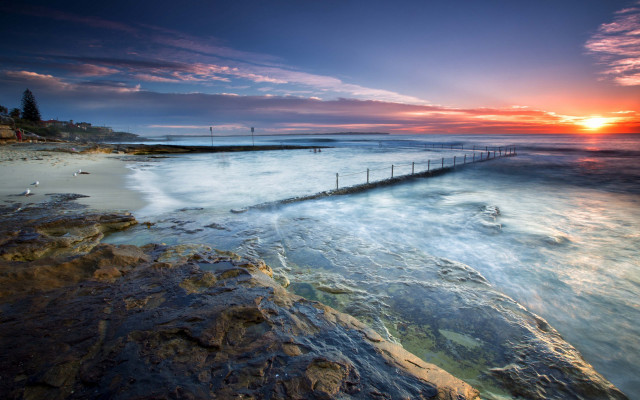 Long pier rocky beach sunset #2 free wallpaper - medium preview image