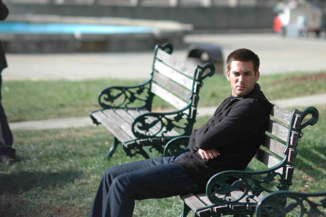 Man sitting bench park arms free wallpaper - medium preview image