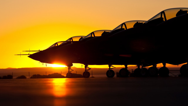 Jet fighter sunset backlit burning free wallpaper - medium preview image