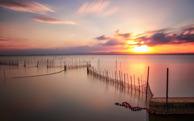 Sunset water fence poles cinematic free wallpaper - medium preview image