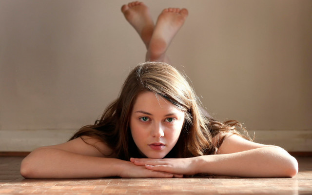 Woman lying crossed legs green free wallpaper - medium preview image