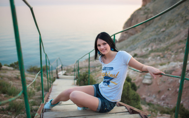 Woman ocean cliff fishing blurry free wallpaper - medium preview image