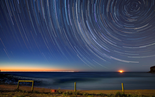 Star trail ocean night lighthouse free wallpaper - medium preview image