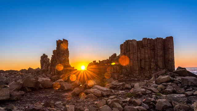 Sunset rocky beach lens flare free wallpaper - medium preview image