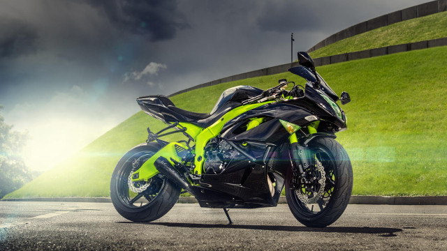 Motorcycle hill grass cloudy sky free wallpaper - medium preview image
