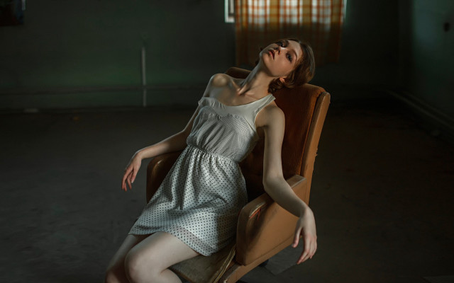 Woman sitting dark room portrait free wallpaper - medium preview image