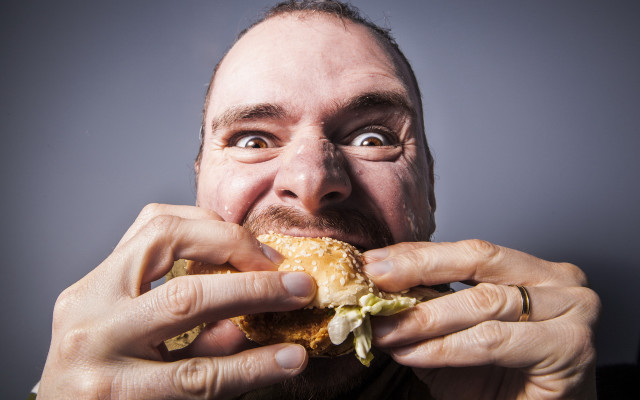 Man eating sandwich wide eyed free wallpaper - medium preview image