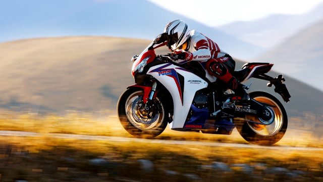 Motorcycle rider mountains grass sky free wallpaper - medium preview image