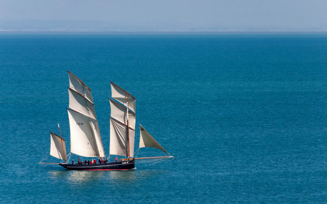 Sailboat ocean sky people beach free wallpaper - medium preview image