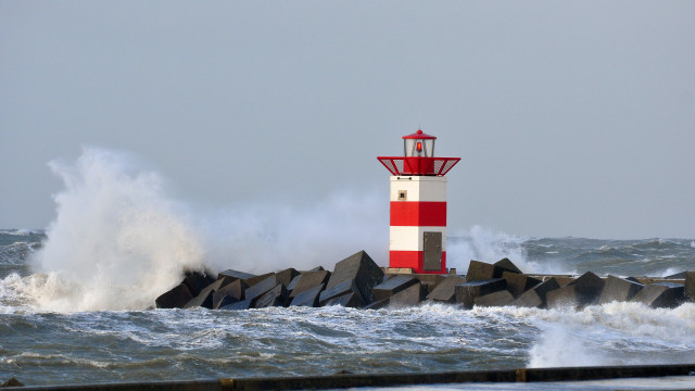 Lighthouse waves stormy beach cloud free wallpaper - medium preview image