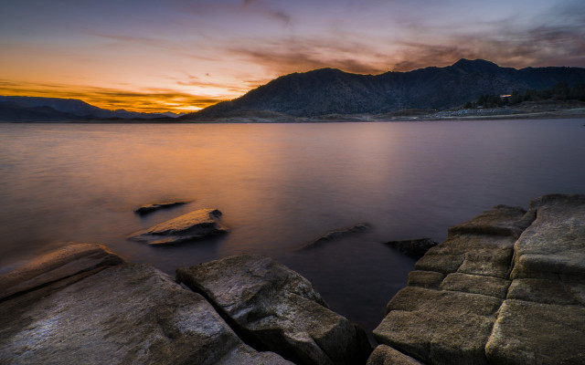 Sunset lake rocks mountains clouds free wallpaper - medium preview image