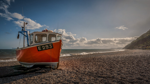 Boat beach ocean cloudy mountain free wallpaper - medium preview image