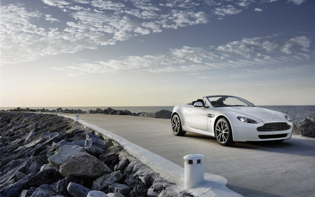 White sports car ocean rocks free wallpaper - medium preview image