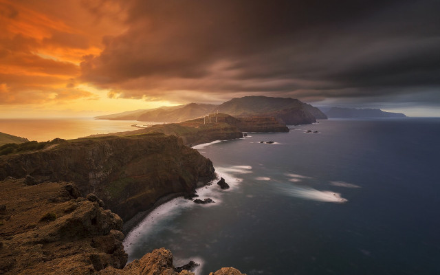 Sunset coastline mountains water clouds free wallpaper - medium preview image